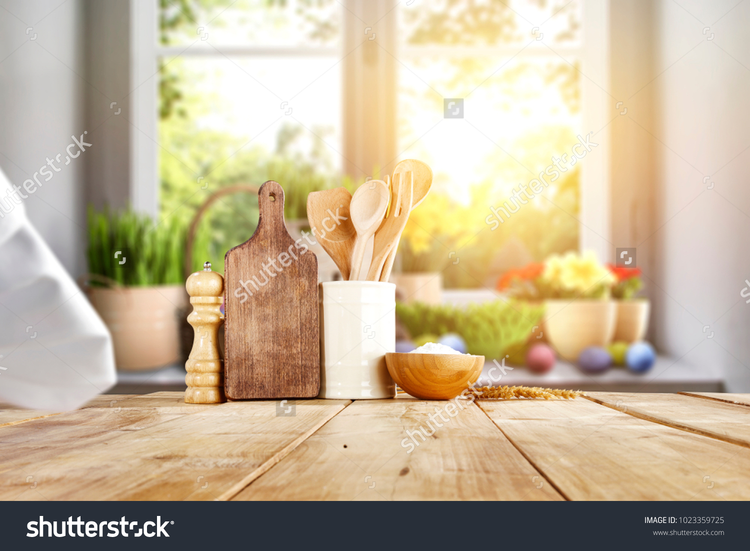 Easter table with spring flowers in a sunny April kitchen #1023359725