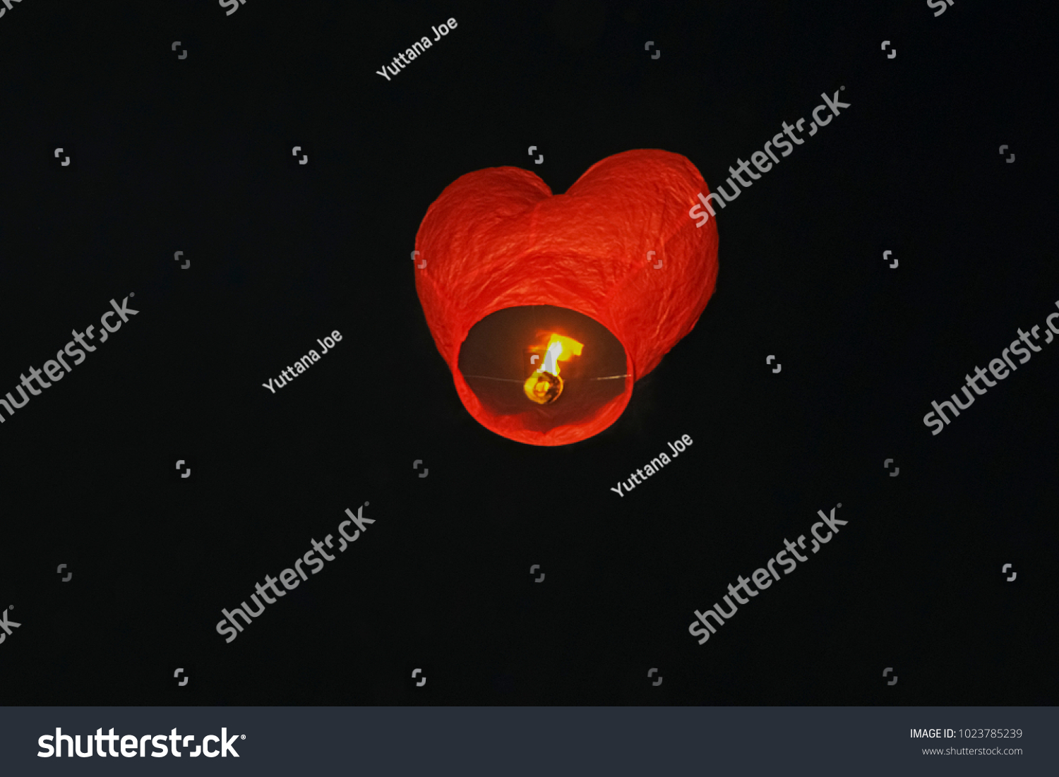 Red lantern balloon shape heart floating with dark sky background #1023785239