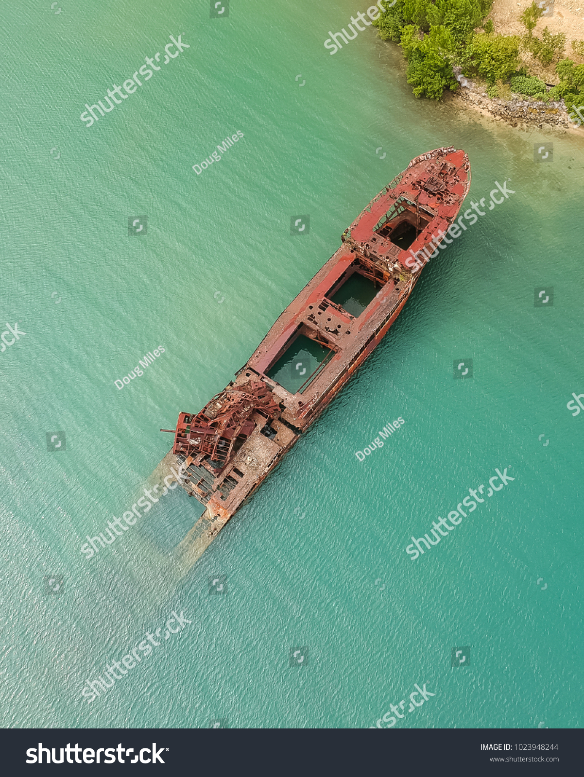 Half Submerged Shipwreck In Harbor #1023948244