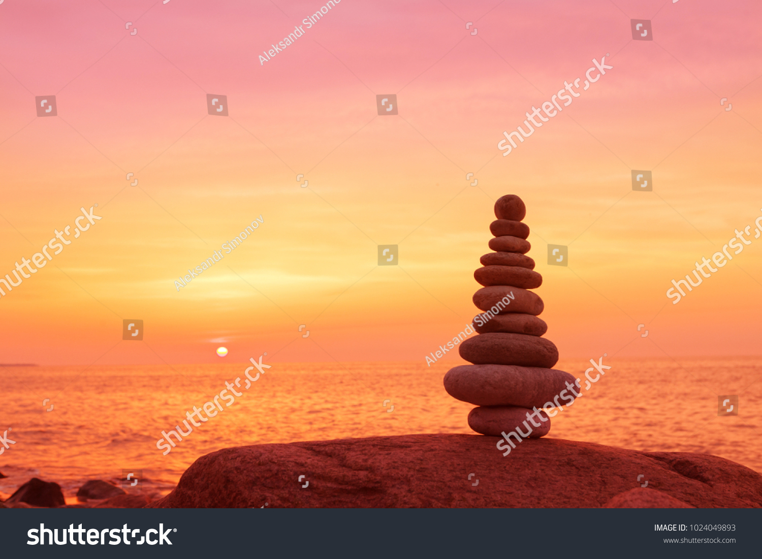 Stones balance on a background of sea sunset. Calm and meditation. Concept of harmony and balance #1024049893