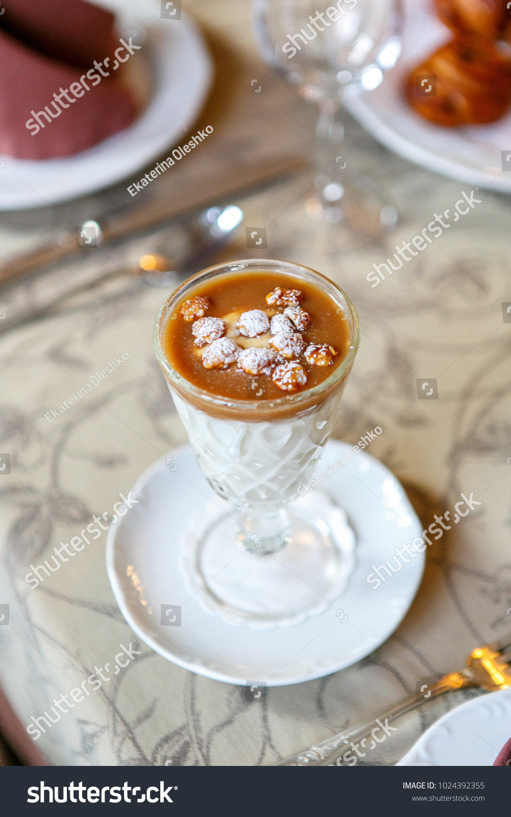 Dessert in a glass on a serving table. Serving dishes in a restaurant, cafe. Beautiful decoration of food. Close up. View from above. Single #1024392355