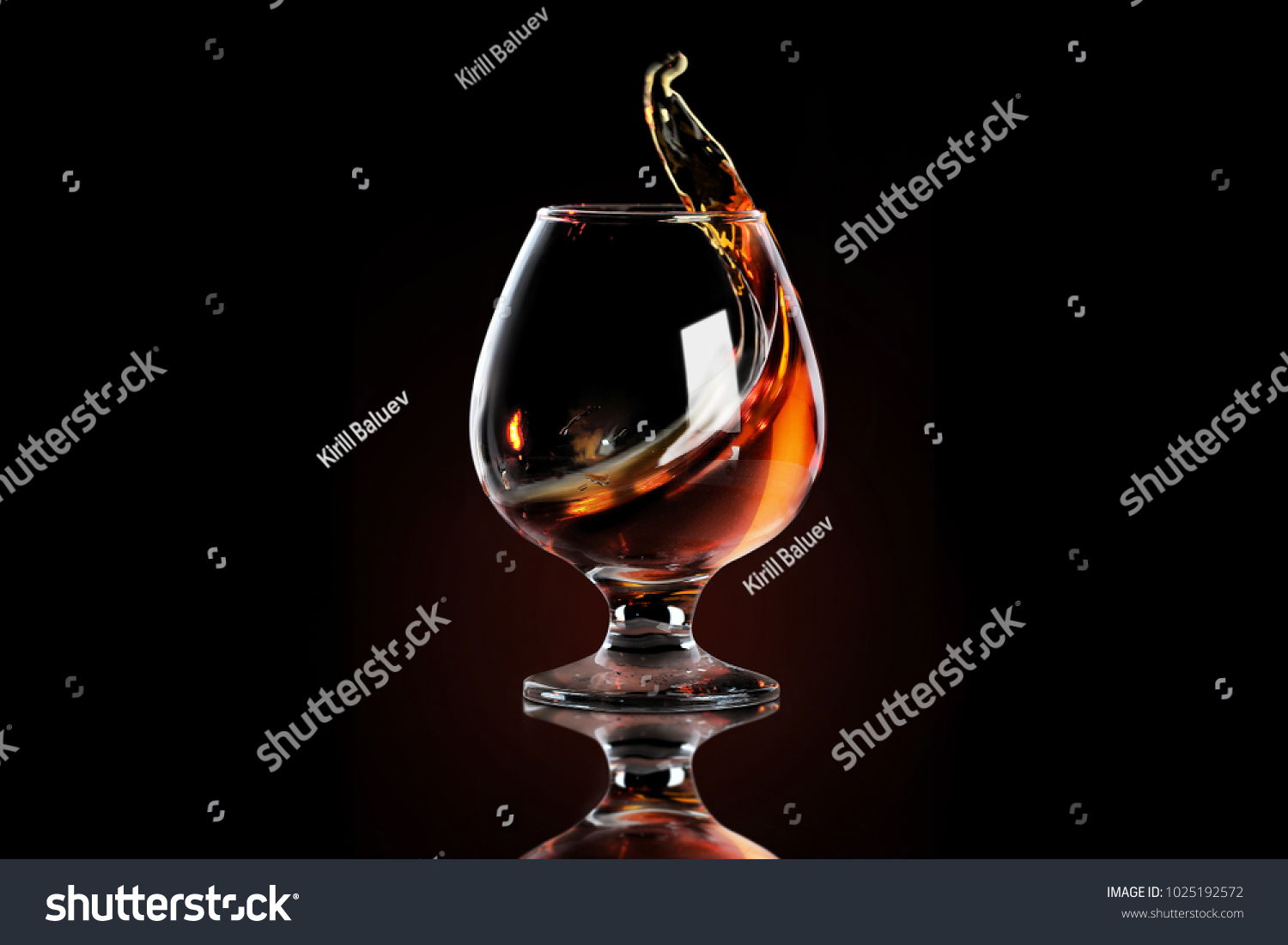 Splash of cognac in glass #1025192572