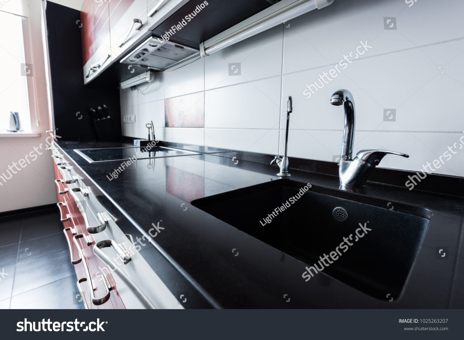 close up view of sink and faucets in kitchen #1025263207