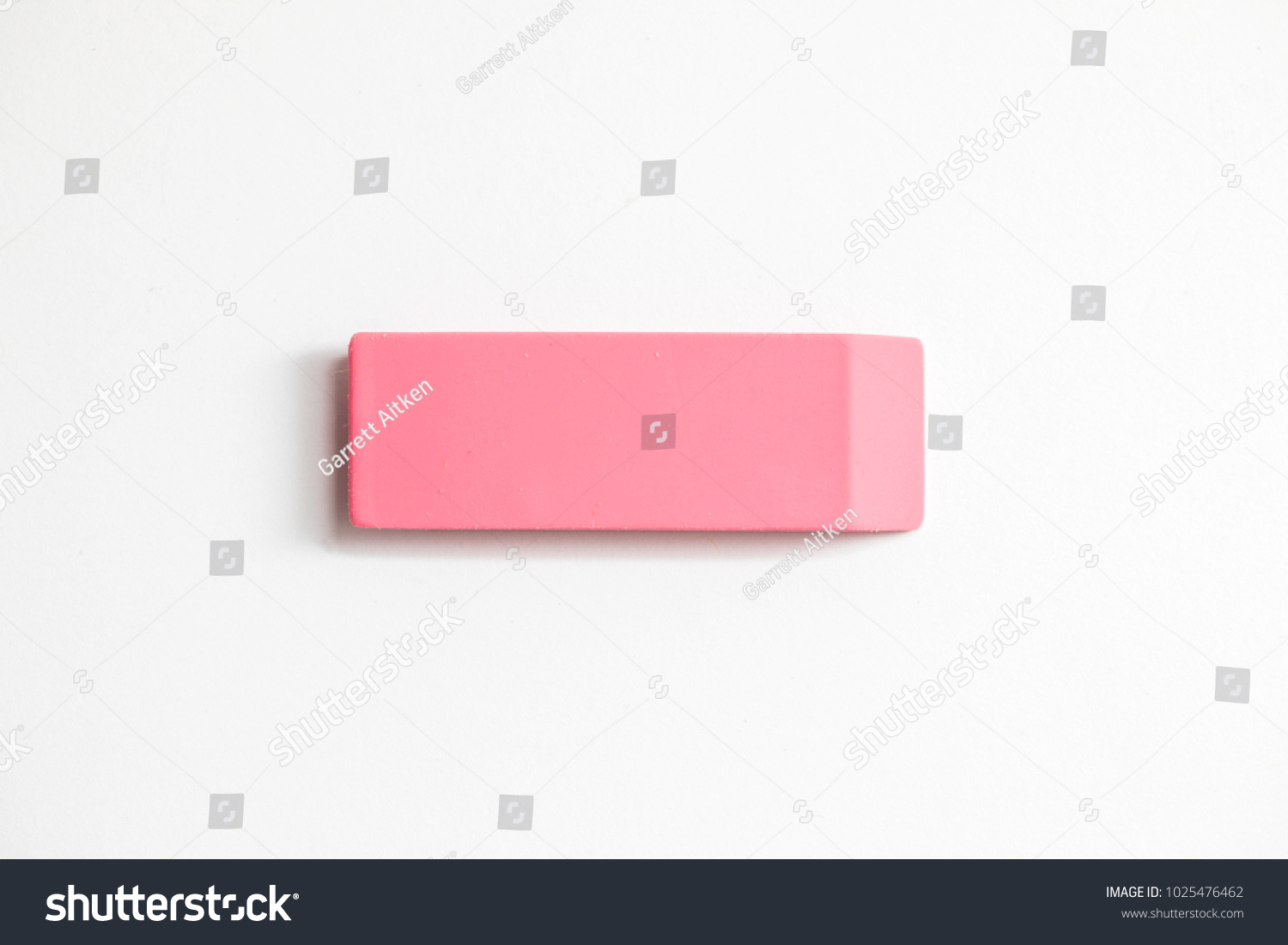 Pink eraser shot up close against a white background #1025476462