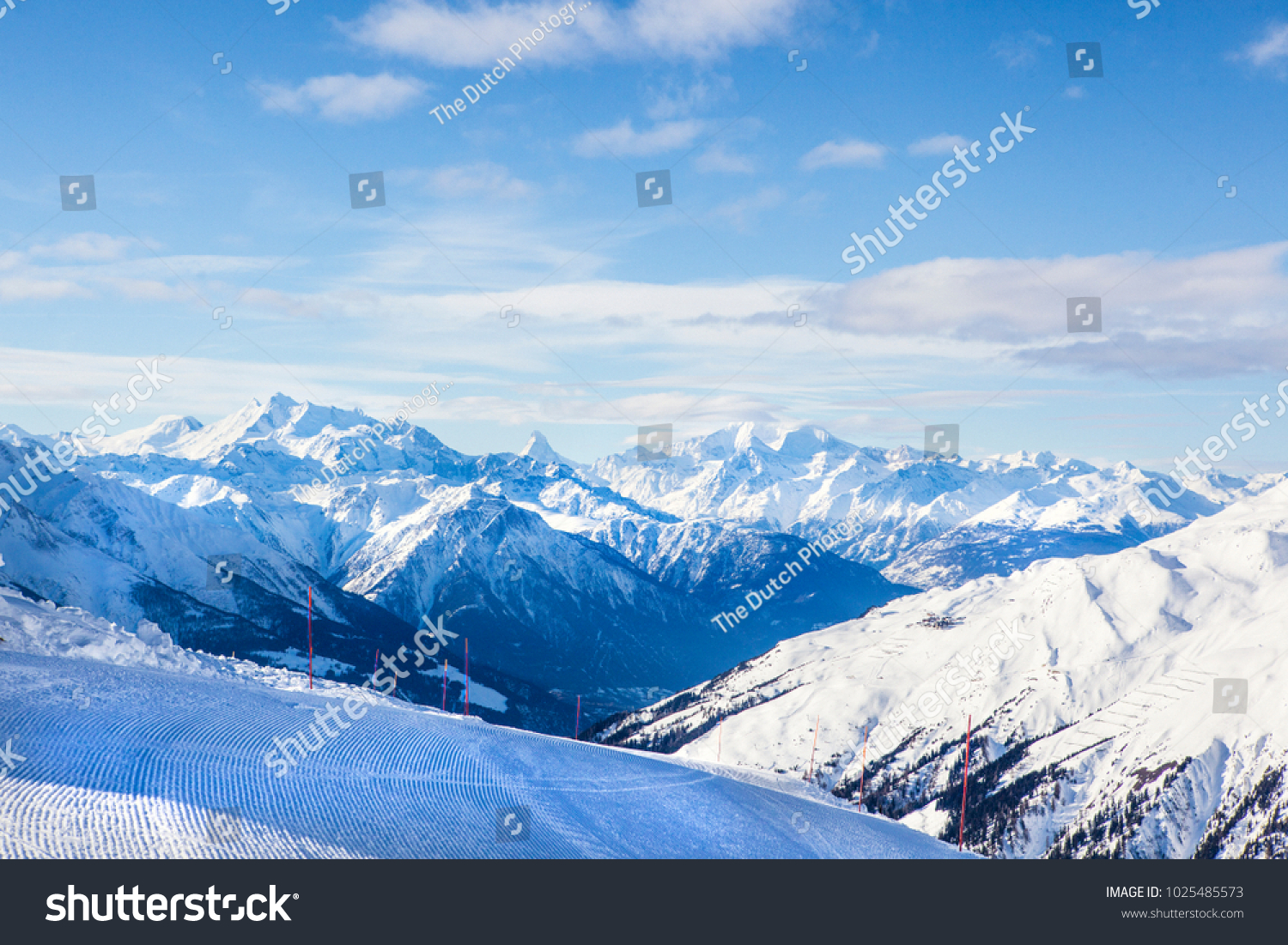 Mountain view on a ski slope with pisten bully traces #1025485573