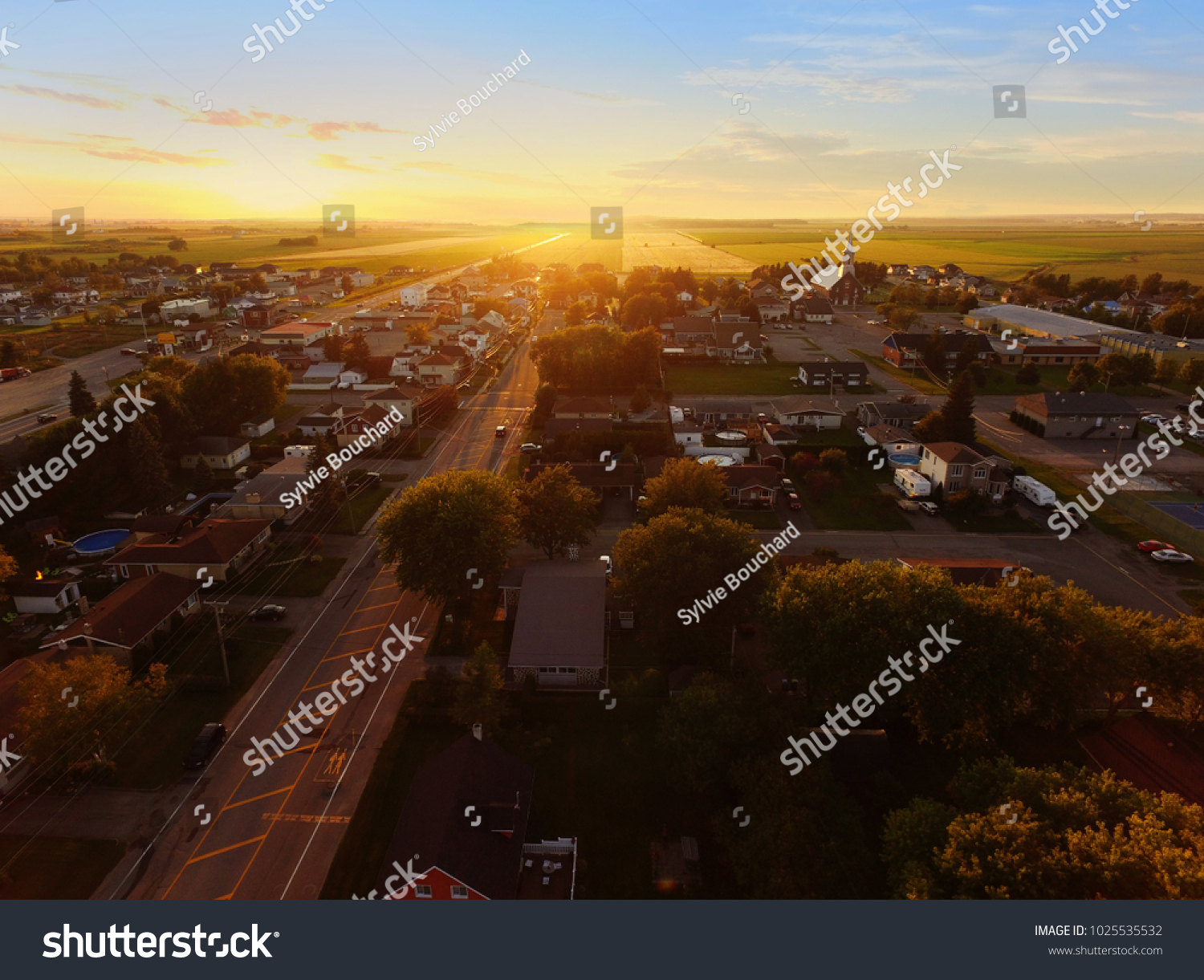 Aerial view of sunset on a small town #1025535532