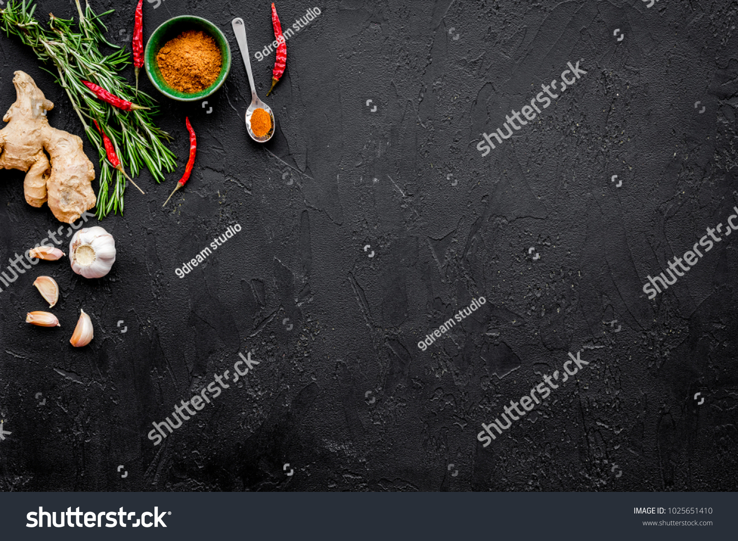 Gastronomy, culinary. Secrets of tasty dishes. Seasoning and spices. Rosemary, ginger, chili pepper on black background top view copy space #1025651410