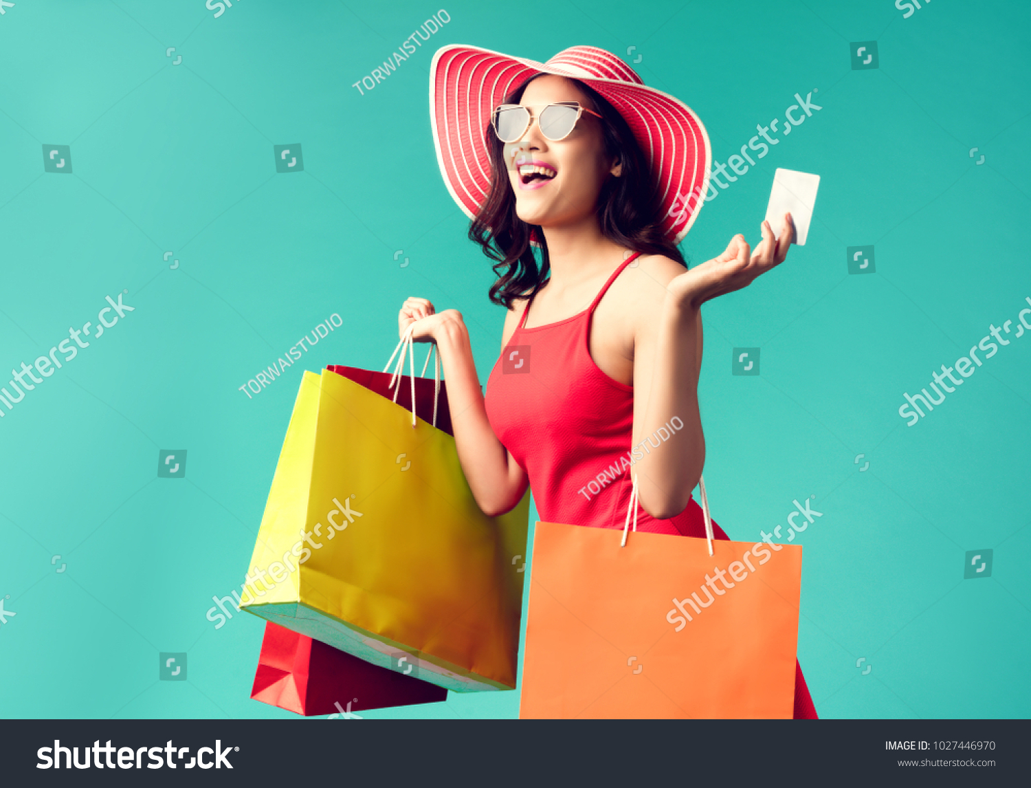 Women are shopping In the summer she is using a credit card and enjoys shopping. #1027446970
