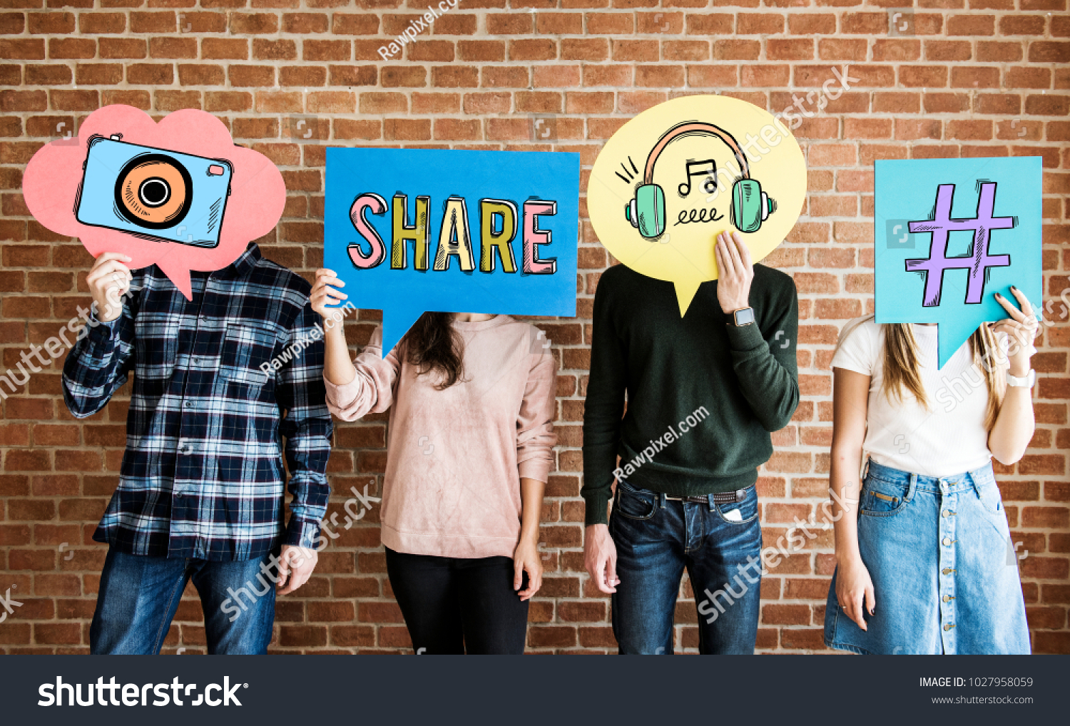 Friends holding up thought bubbles with social media concept icons #1027958059