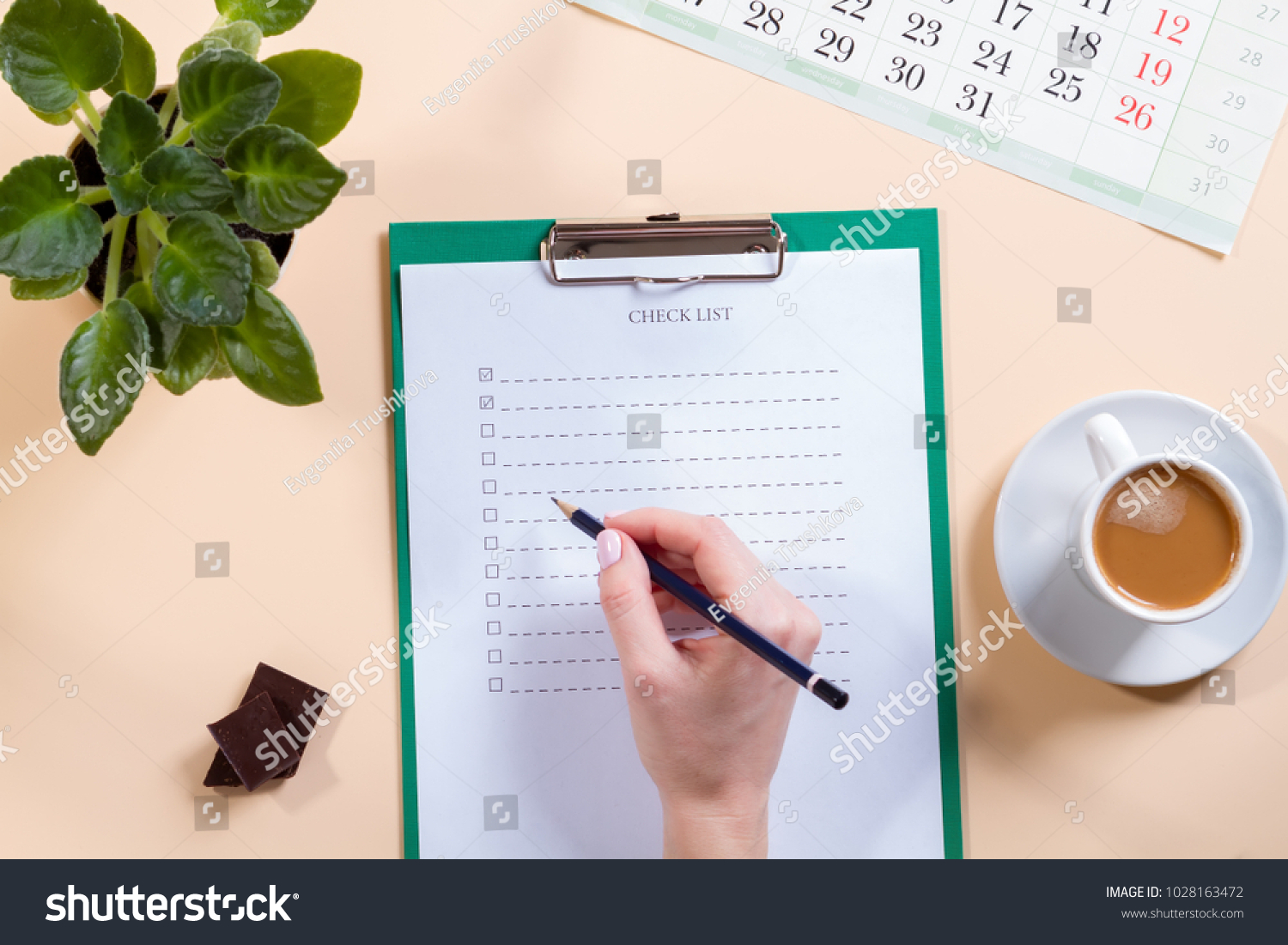Mockup for check list, empty note paper with pen and coffee cup on light background. Office, writer or study concept. female hand with a pencil #1028163472