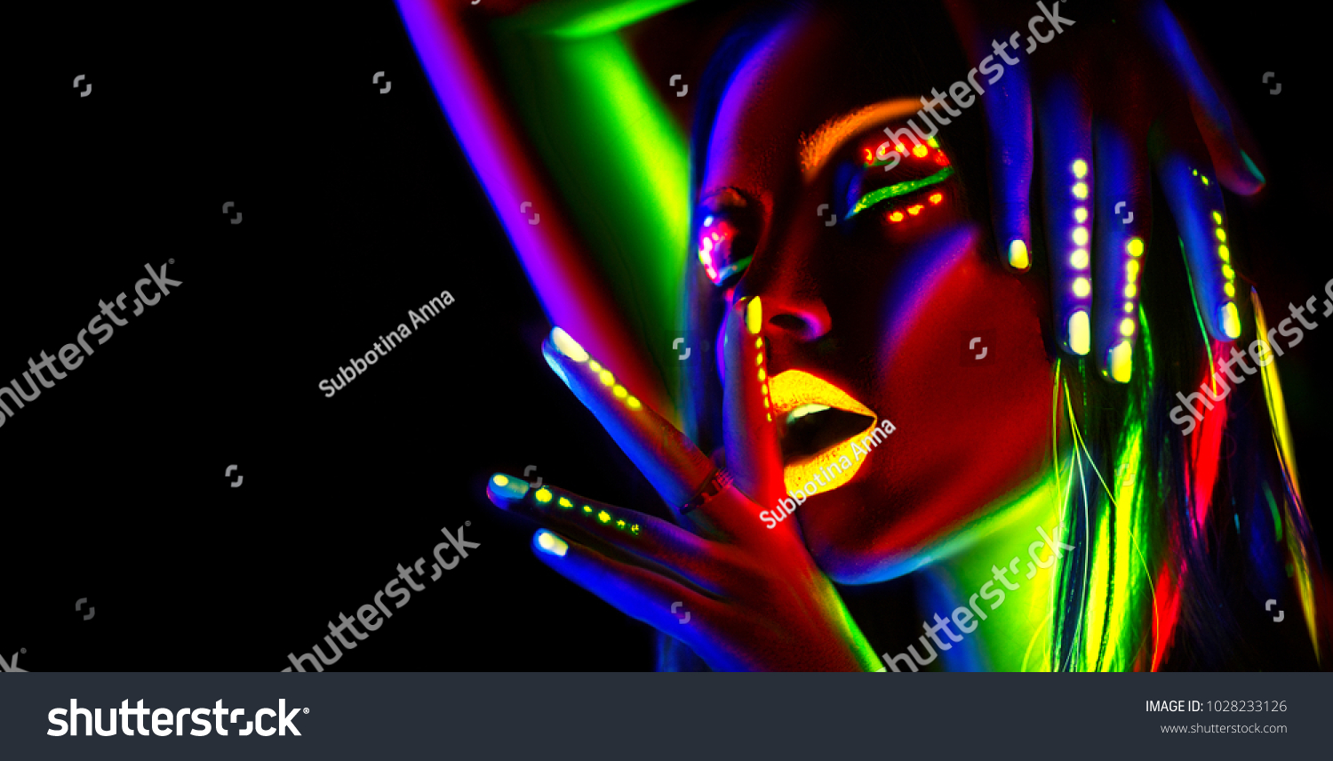 Disco dancer in neon light. Fashion model woman in neon light, portrait of beautiful model girl with fluorescent make-up, Body Art design in UV, painted face, colorful make up, over black background #1028233126