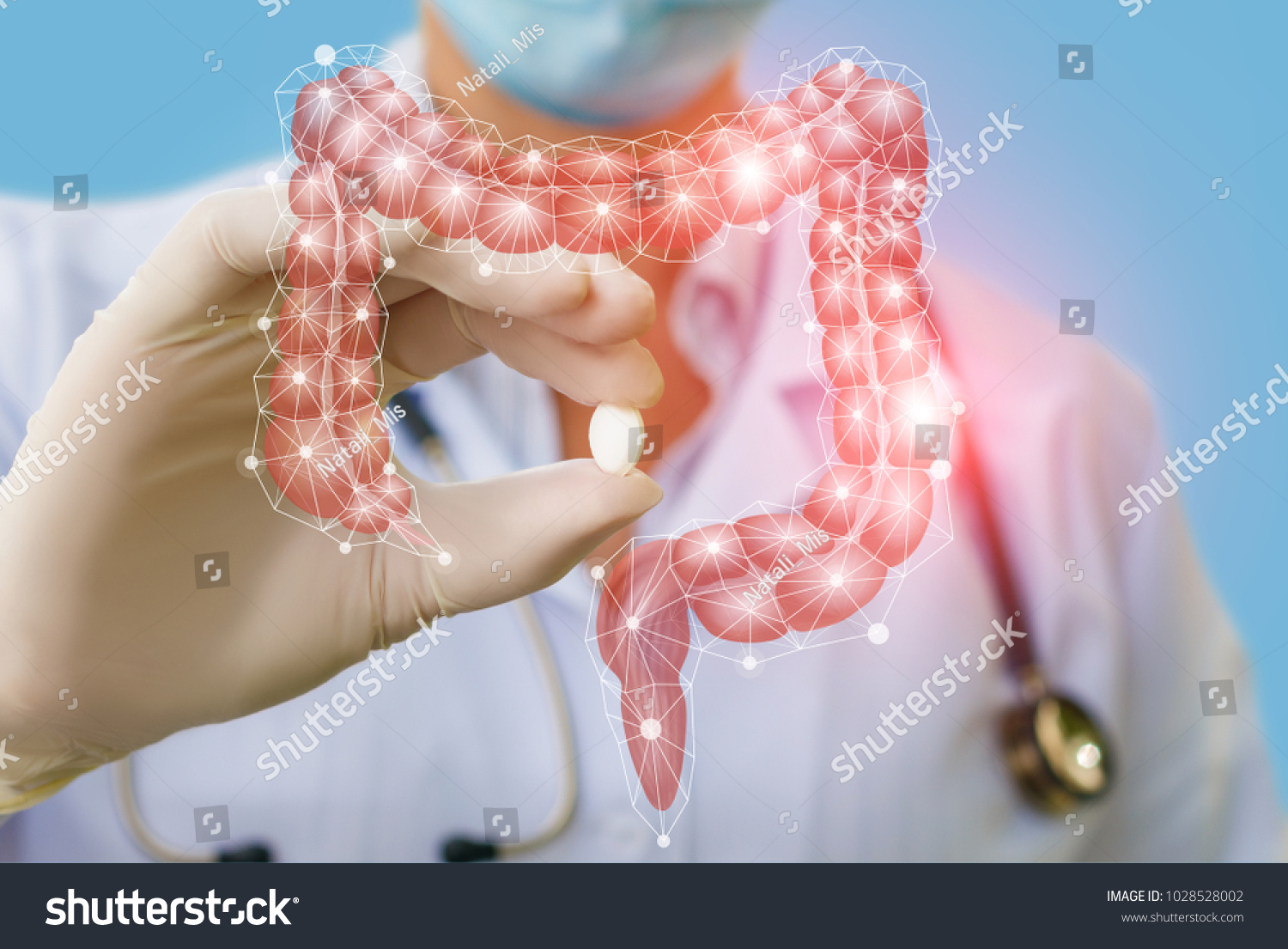A doctor showing a pill to treat gut . The concept of Treatment of the digestive system. #1028528002