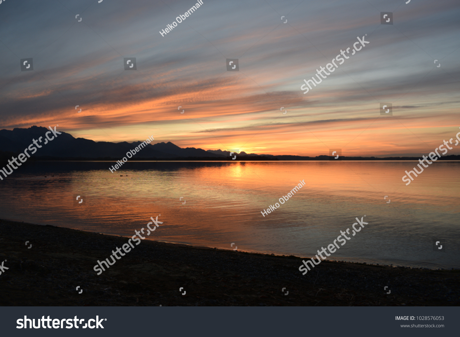 Sunset at Chiemsee, with some beautyful colours. Would make a nice backround for shoure. #1028576053