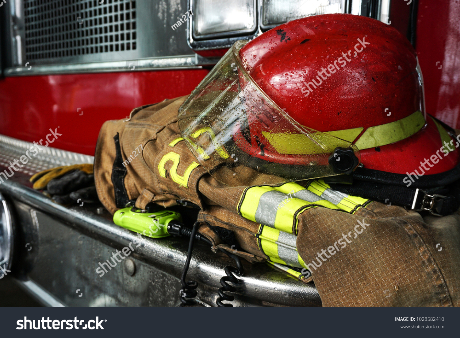 Firefighter gears on the bumper of the fire truck #1028582410