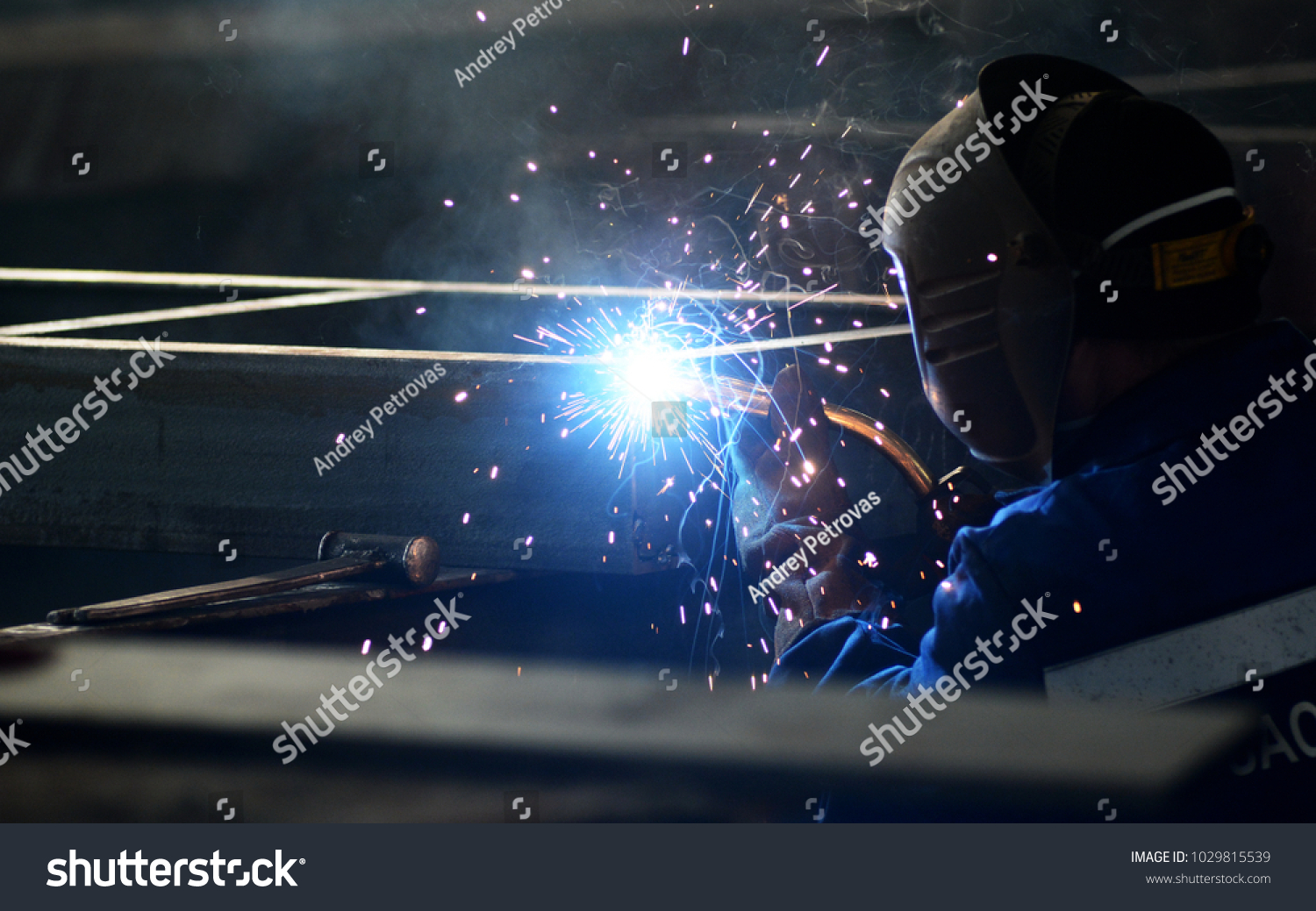 worker in welding mask welding metal construction #1029815539