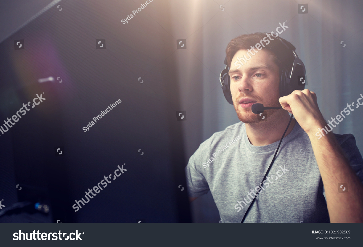 technology, gaming, entertainment, let's play and people concept - young man in headset with pc computer playing game at home and streaming playthrough or walkthrough video #1029902509