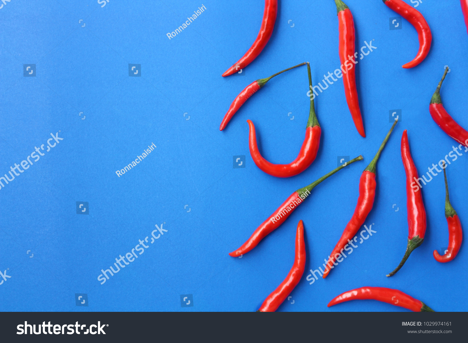 Fresh hot chilies on blue background. #1029974161