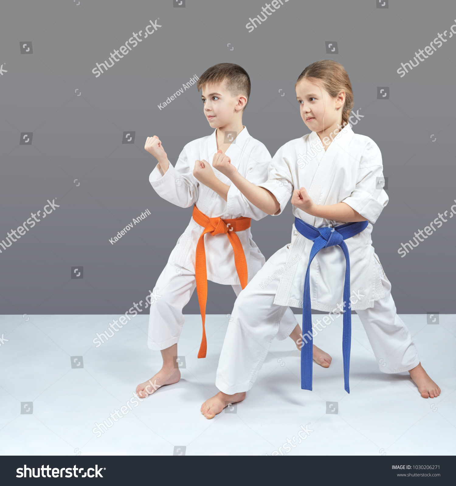 A girl and a boy in karategi stand in a karate rack #1030206271