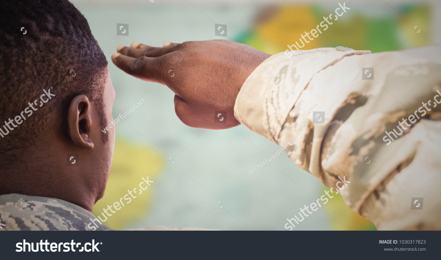 Digital composite of Back of soldier saluting against blurry map #1030317823
