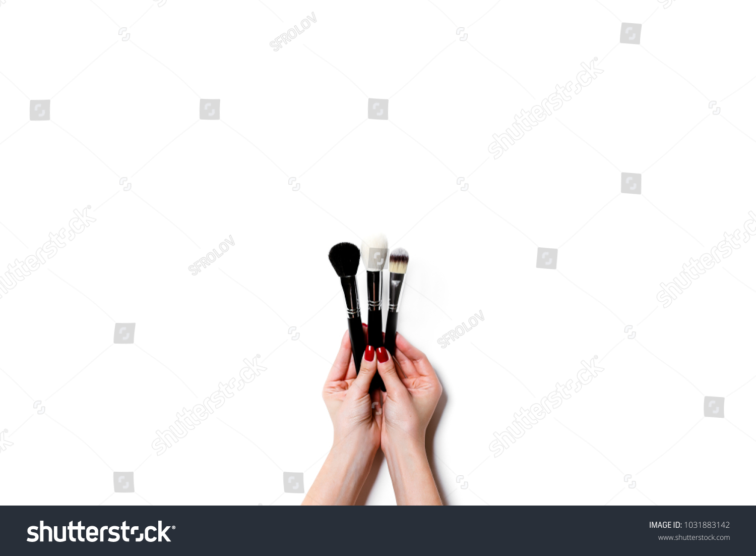 Female hand holding professional make-up brushe isolated on white background #1031883142