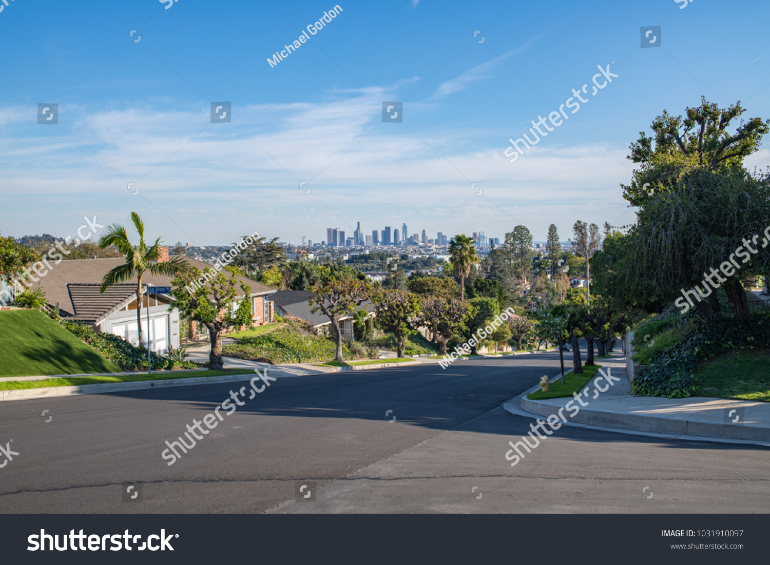 Los Angeles, CA: February 16, 2018:  A Los Angeles residential street with the Downtown Los Angeles skyline in the background.  Los Angeles is the second largest city in the United States. #1031910097