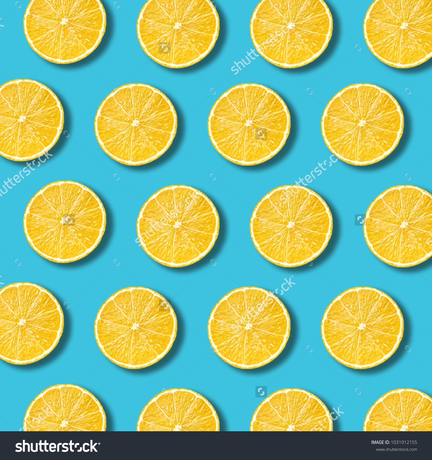 Lemon slices pattern on vibrant turquoise color background. Minimal flat lay food texture  #1031912155