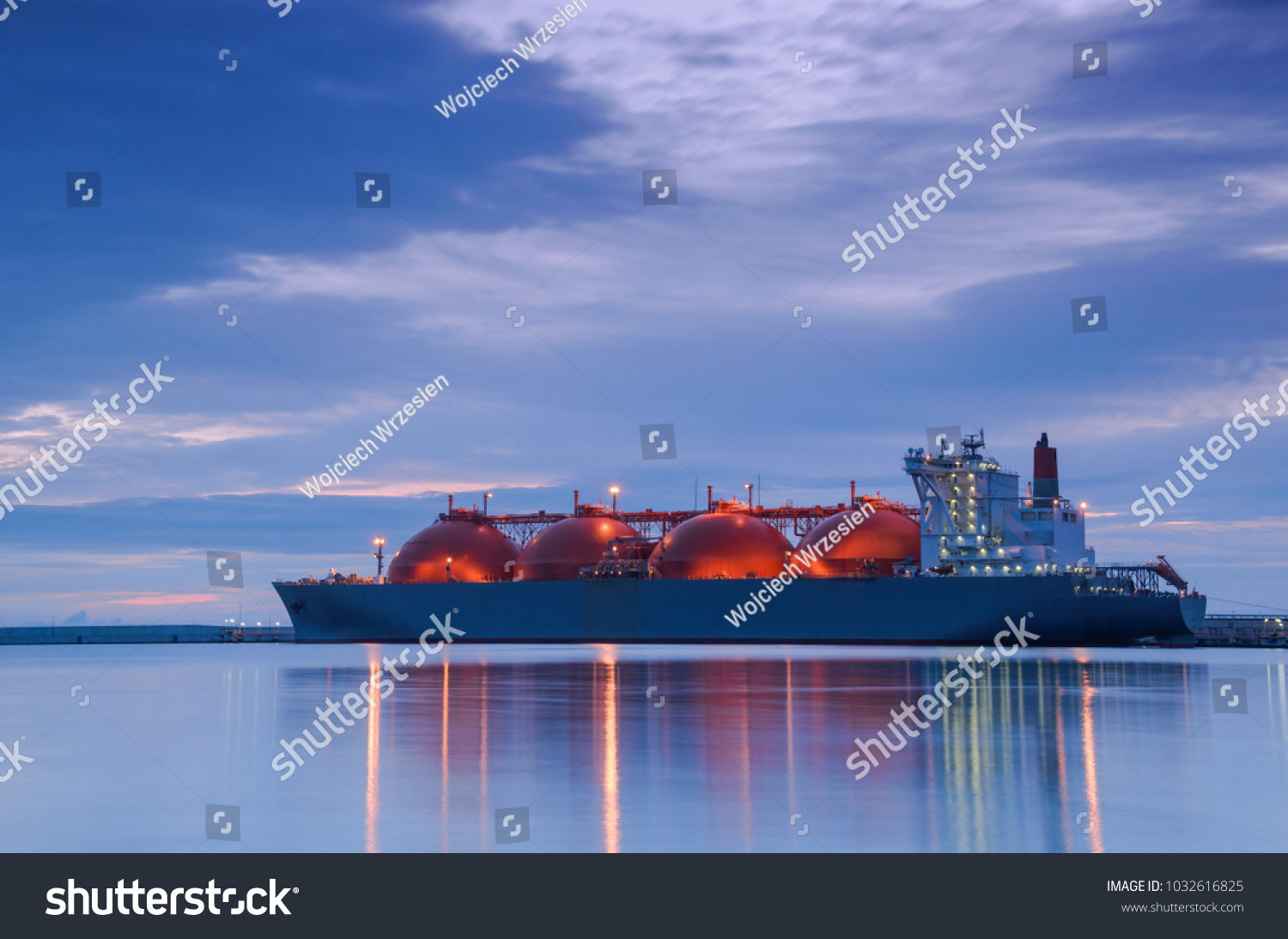 LNG TANKER AT THE GAS TERMINAL - Sunrise over the ship and port #1032616825