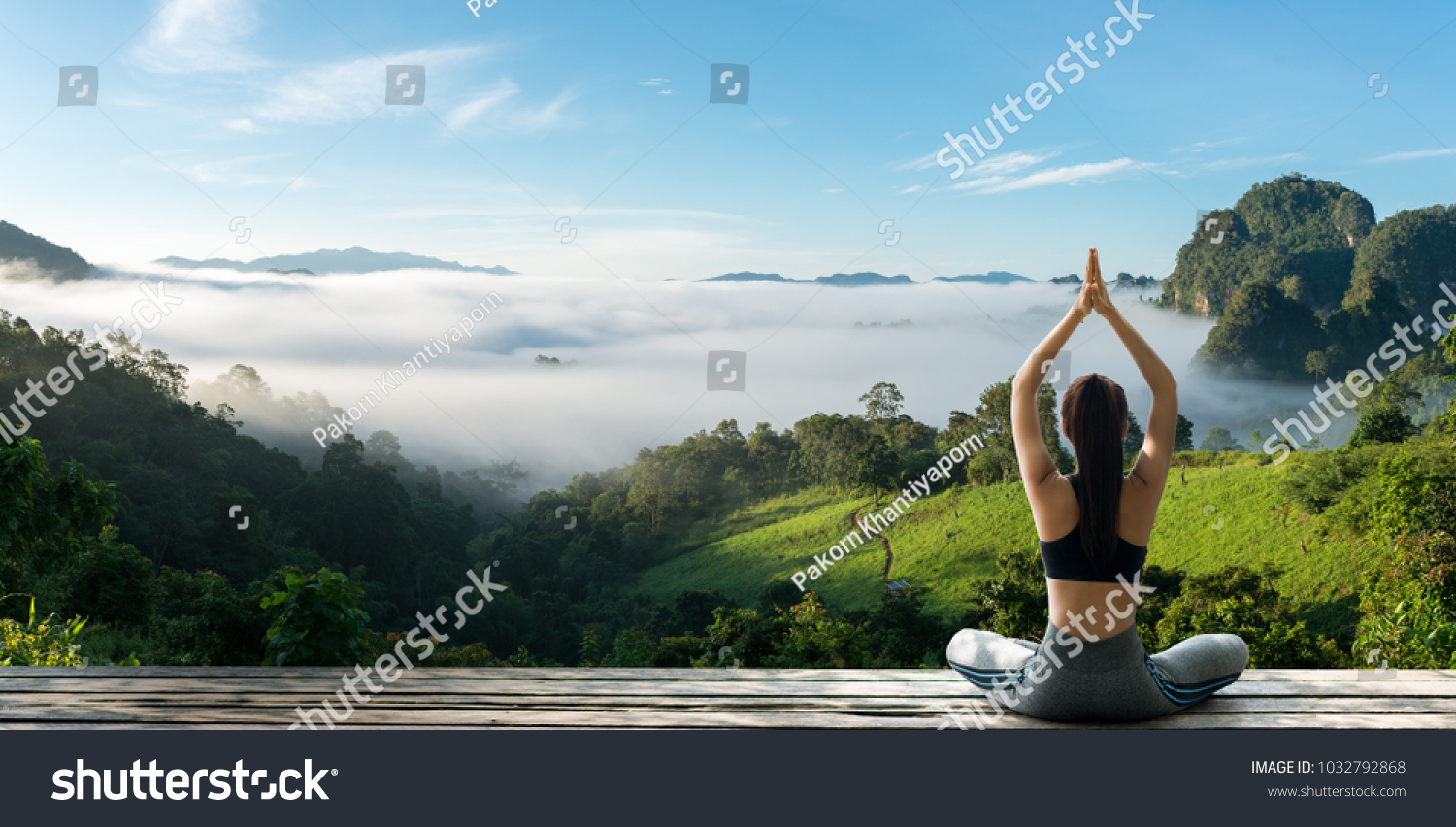 Young woman practicing yoga in the nature.female happiness. Landscape background #1032792868