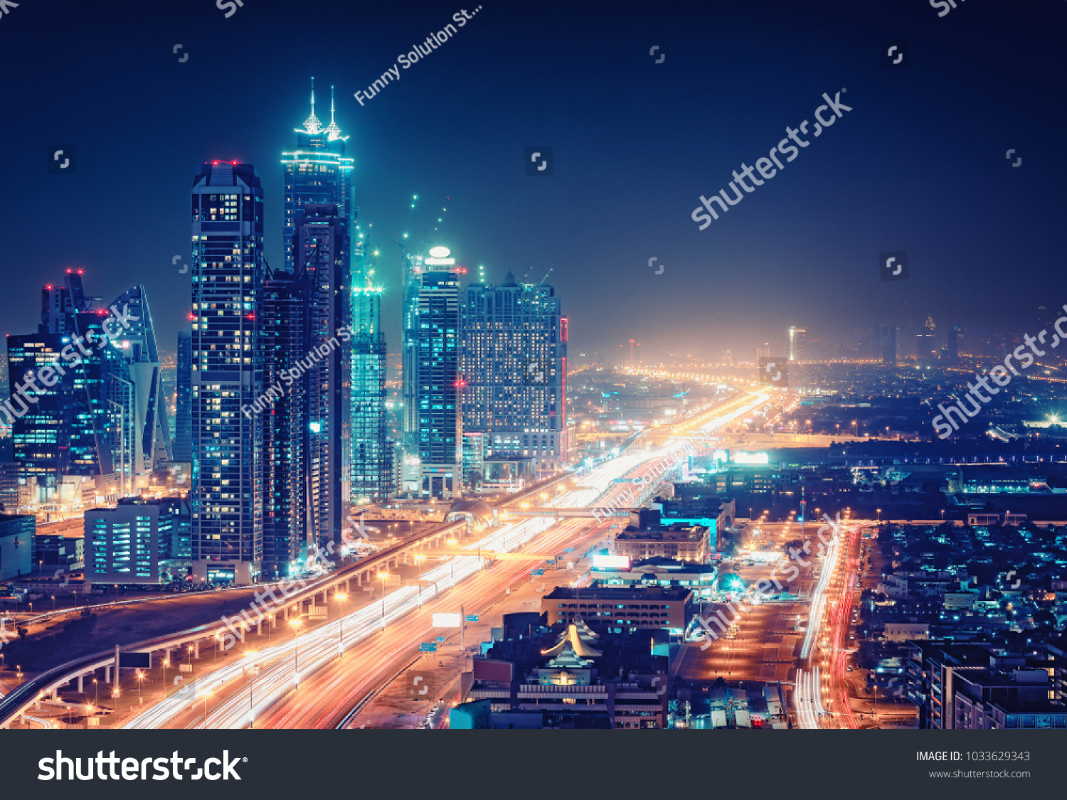 Spectacular nighttime skyline of a big modern city at night
. Dubai, UAE. Aerial view on highways and skyscrapers. #1033629343