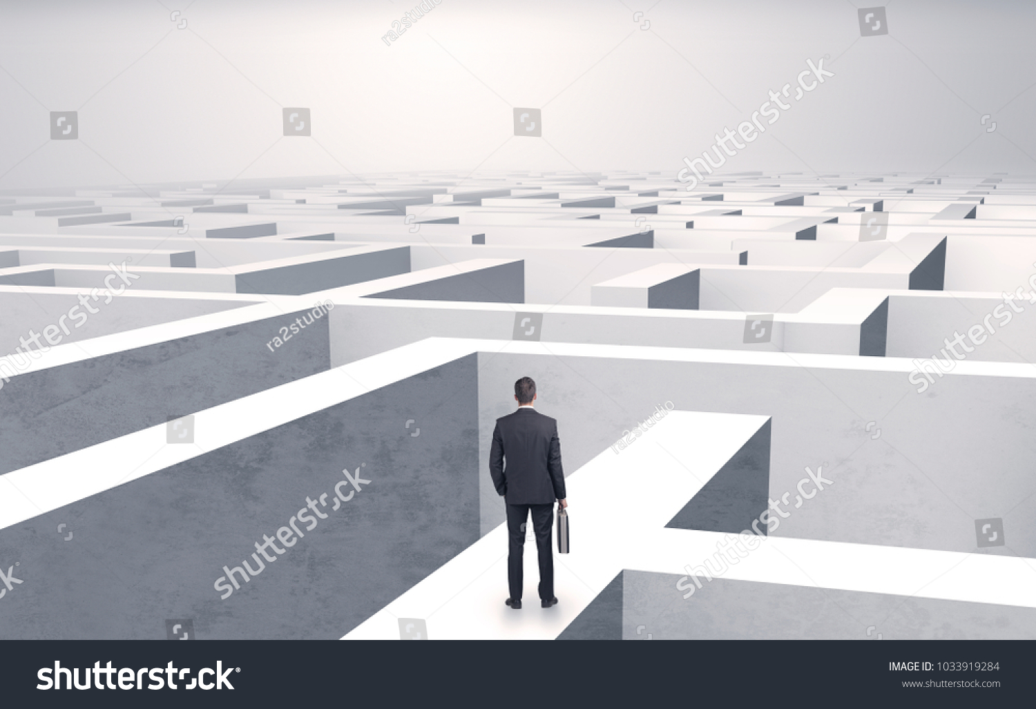 Small businessman in a middle of a huge maze
 #1033919284