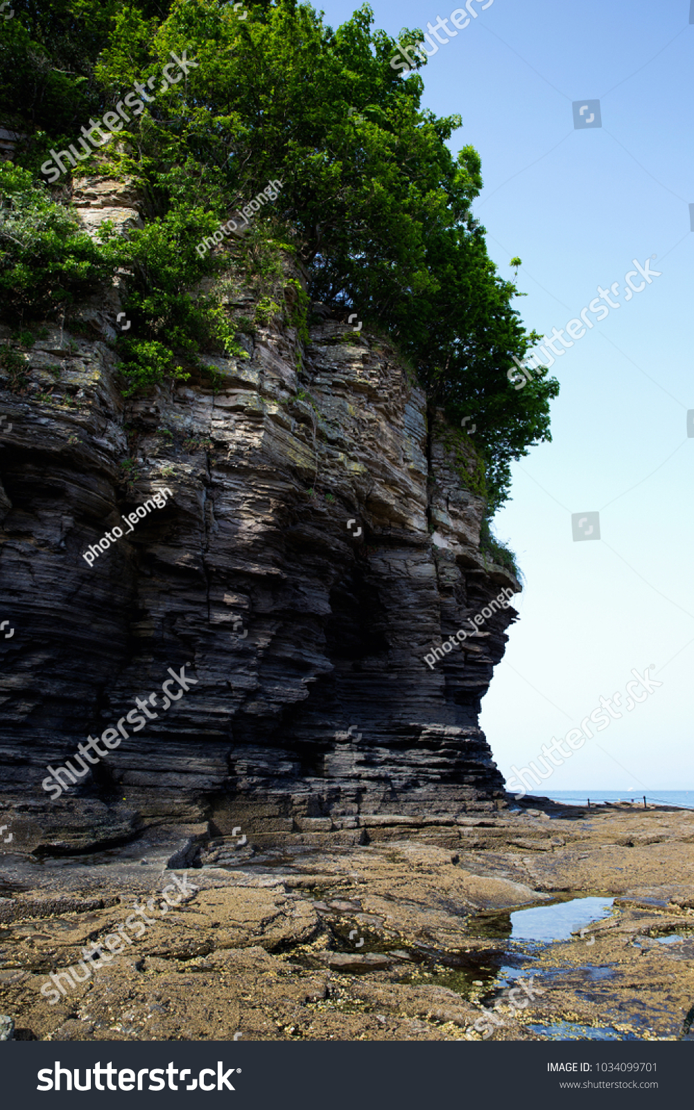 Multistory layered rough and sedimentary rocks in famous tourist site Chaeseokgang Coast in Buan-gun, South Korea. #1034099701
