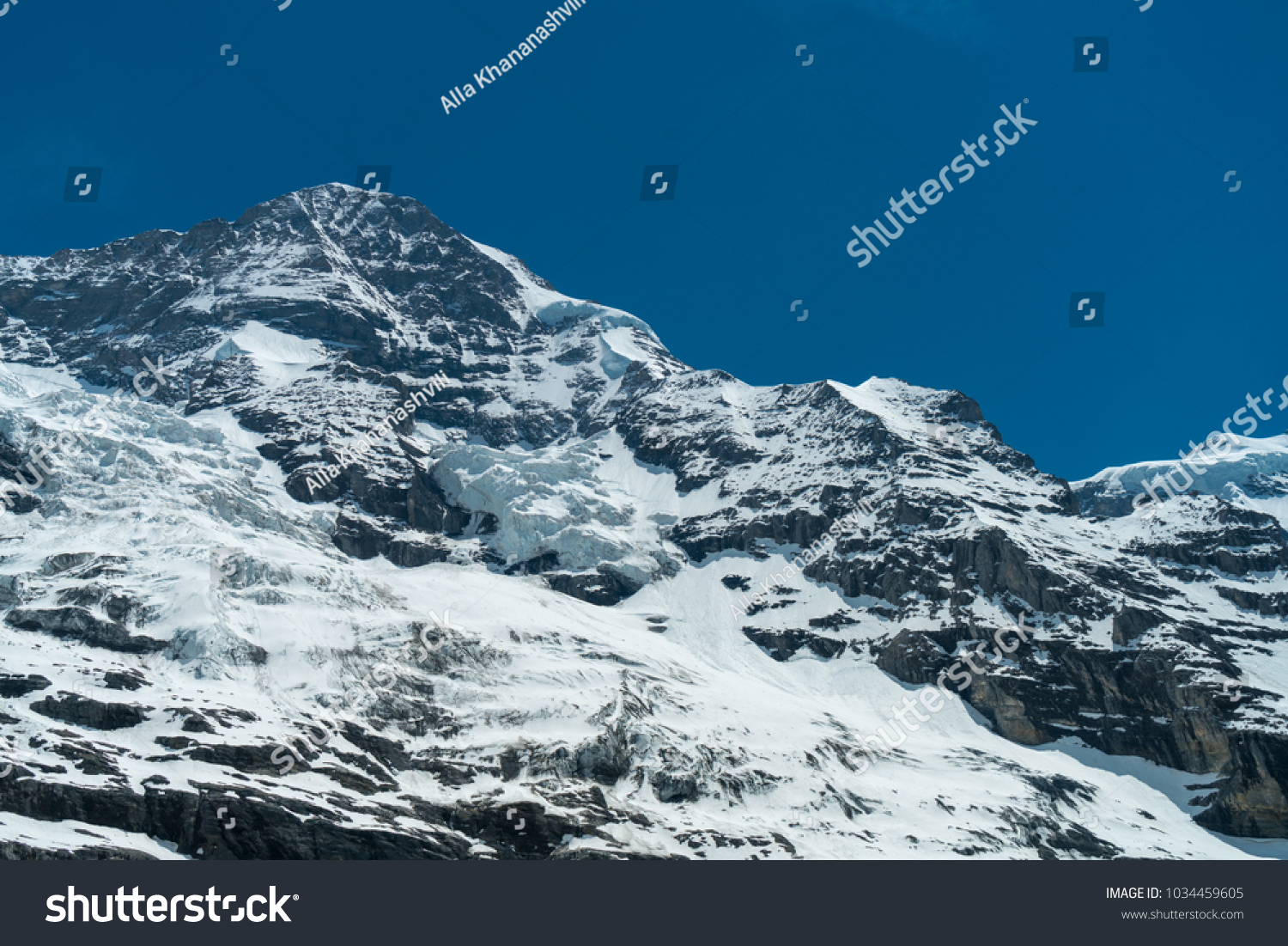 Spectacular view of the mountain Jungfrau and the four thousand meter peaks in the Bernese Alps from Greendeltwald valley, Switzerland #1034459605