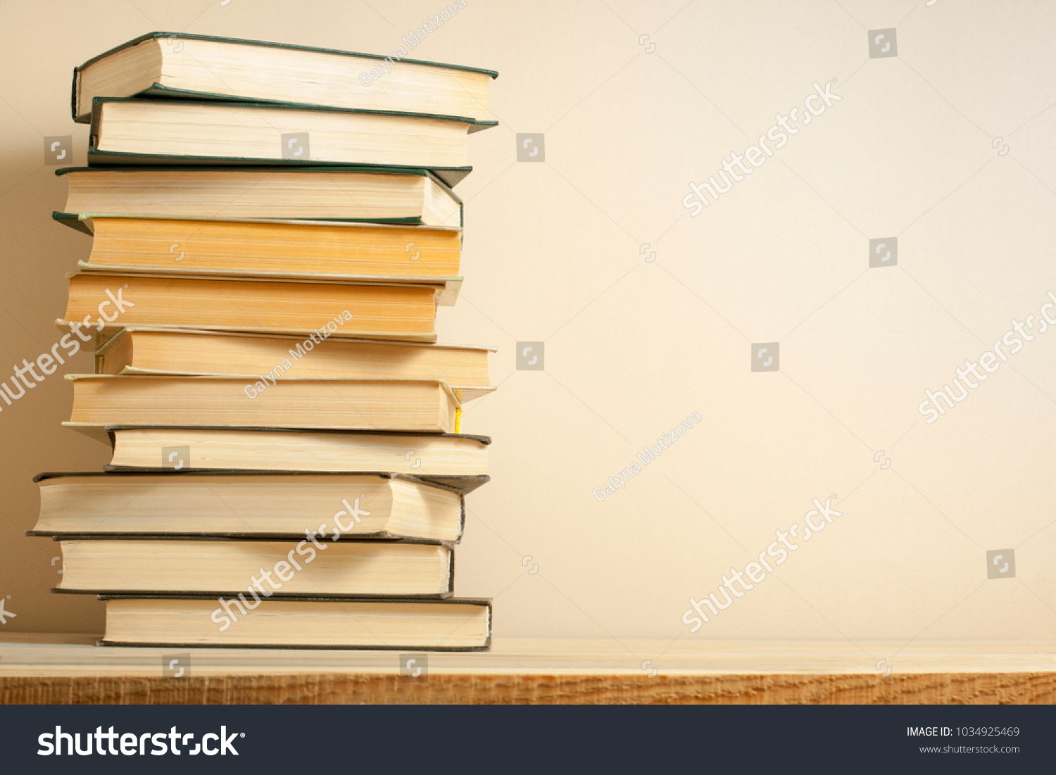 Stack of books on the wooden table. Education background.Back to school. Copy space for text. #1034925469