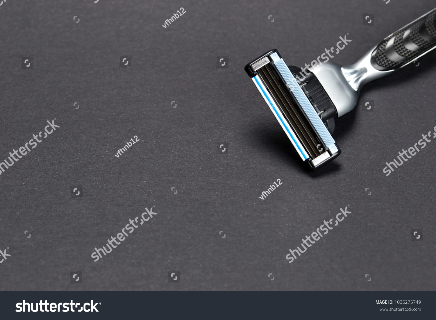 razor on a black background. Close-up of a razor blade. #1035275749