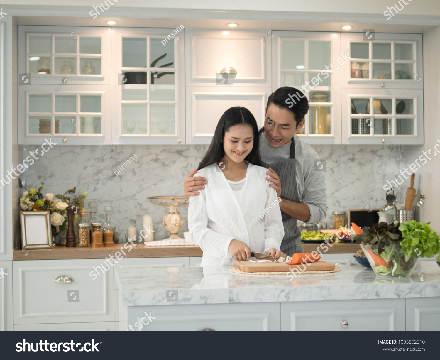 Young asian expecting pregnant couple cooking together in the kitchen at home.
 #1035852310