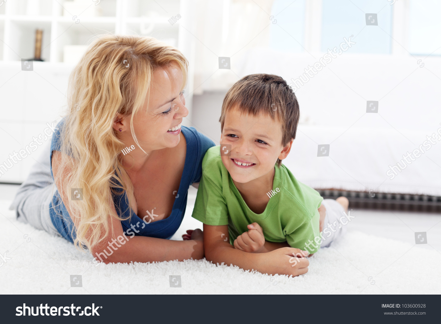 Happy morning - boy playing with mother on the sunlit floor #103600928