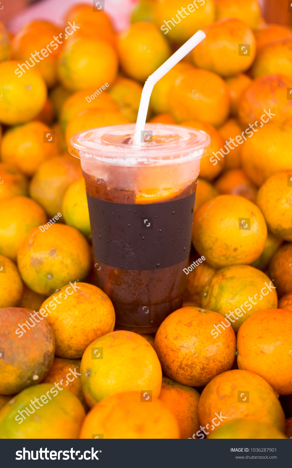 Ice coffee brew mix with orange juice on pile orange #1036287901