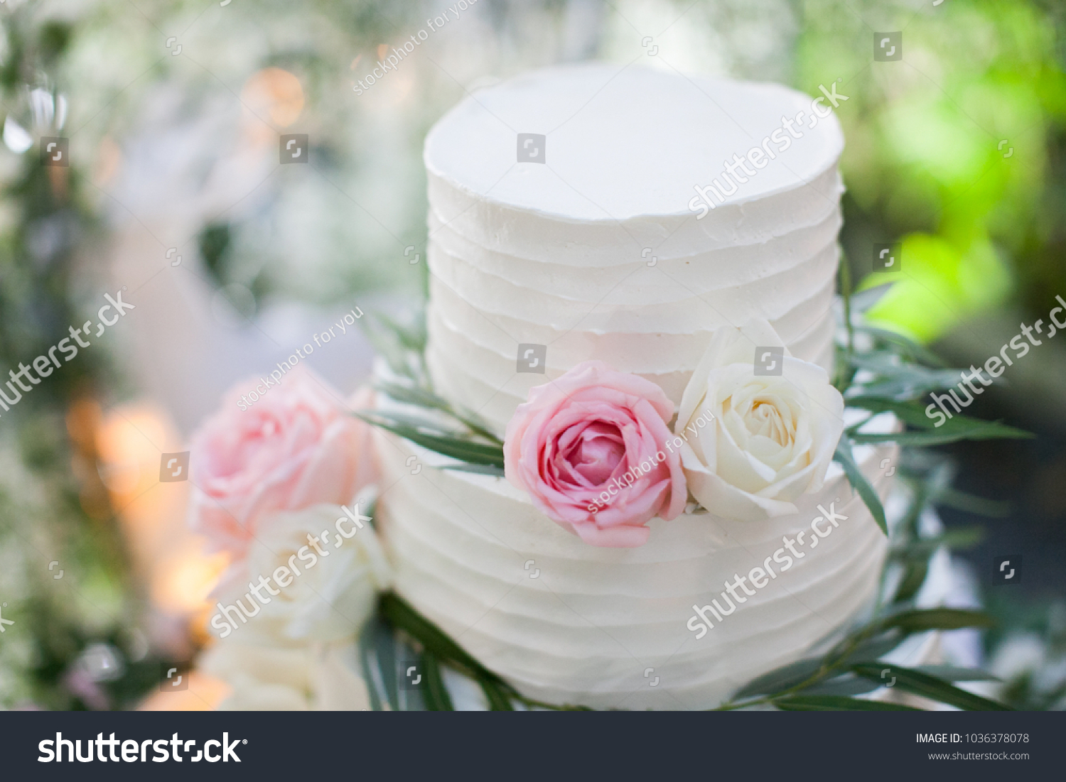 White wedding cake with flowers  #1036378078