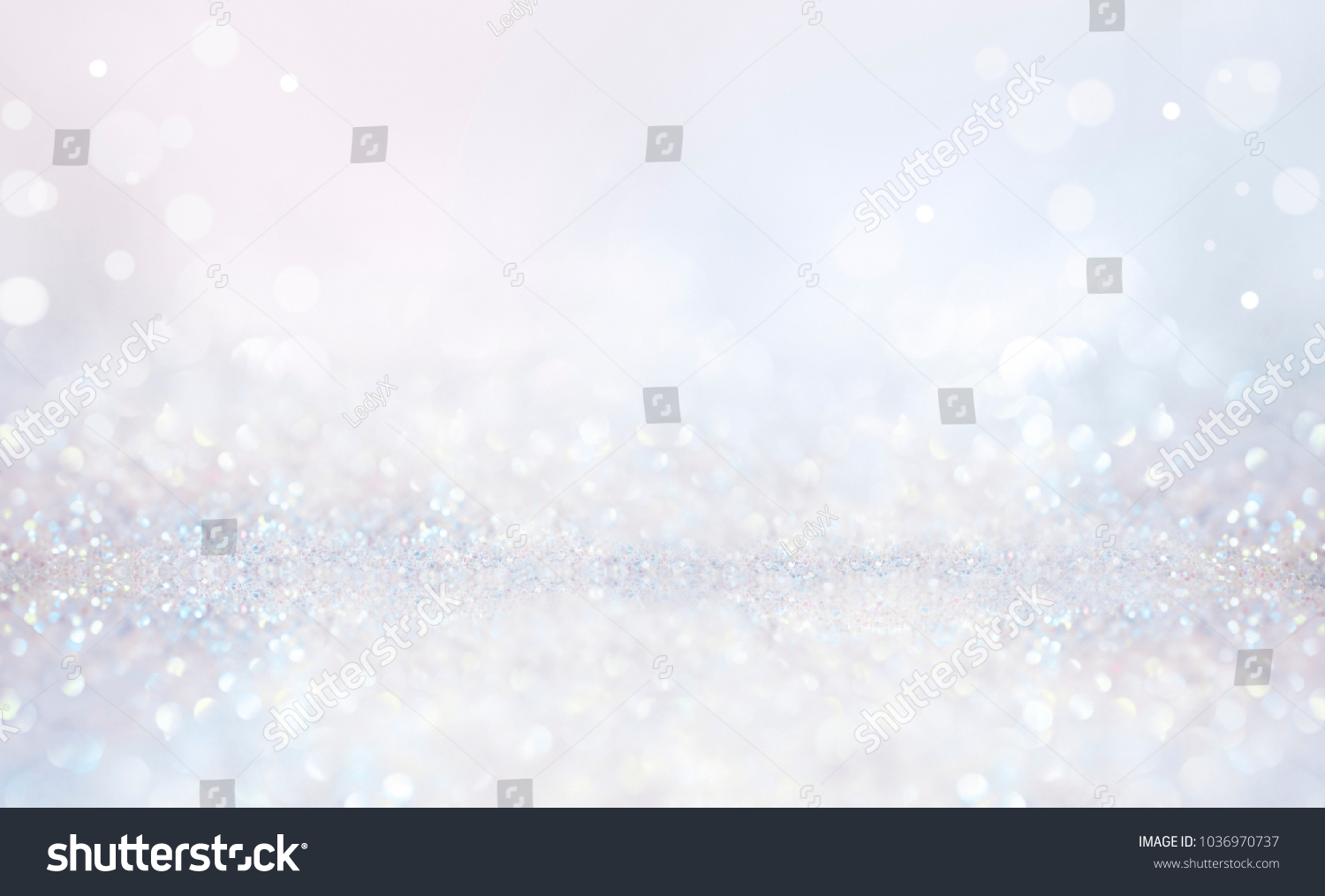 Glitter christmas background in pastel delicate silver and white tones de-focused. #1036970737