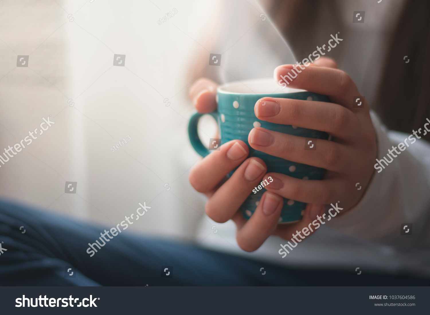 Beautiful young Girl holding her Cup of Coffee and Hot Chocolate-Indoor Atmosphere #1037604586