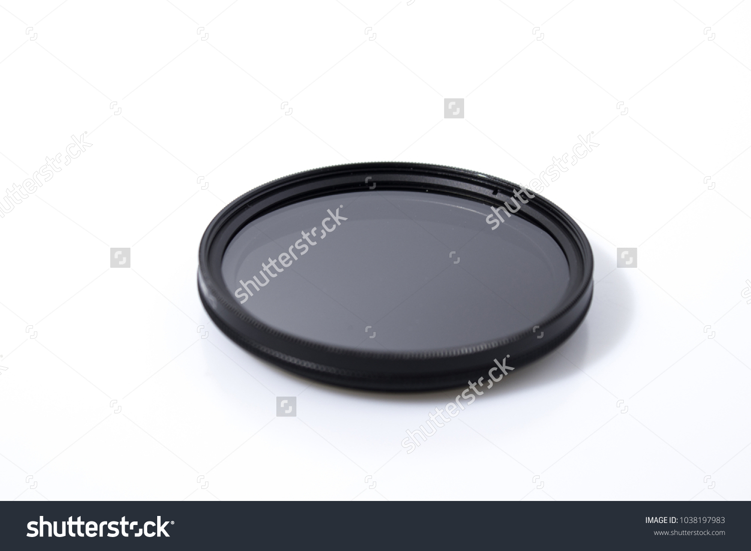 Lens filter reflex polarized filter in a white background composition #1038197983