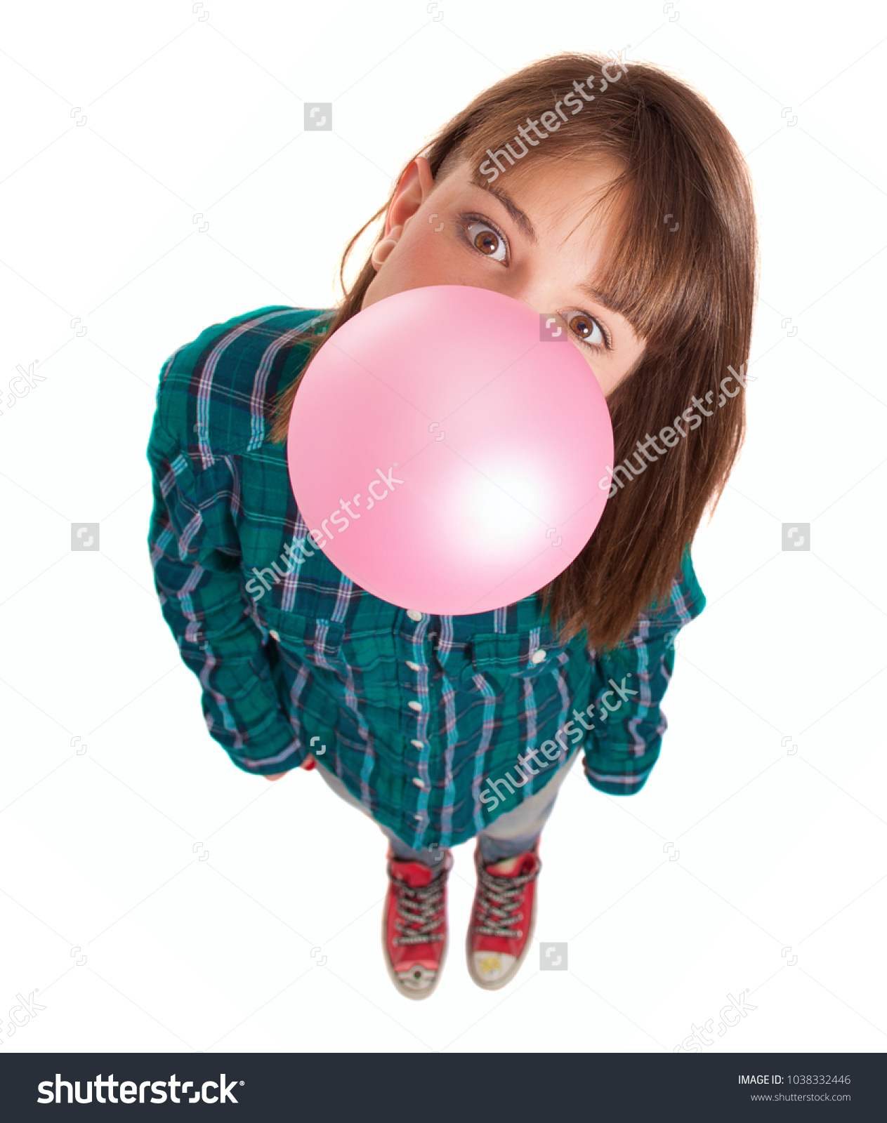 Young Woman Blowing Bubble Gum Over White Background #1038332446