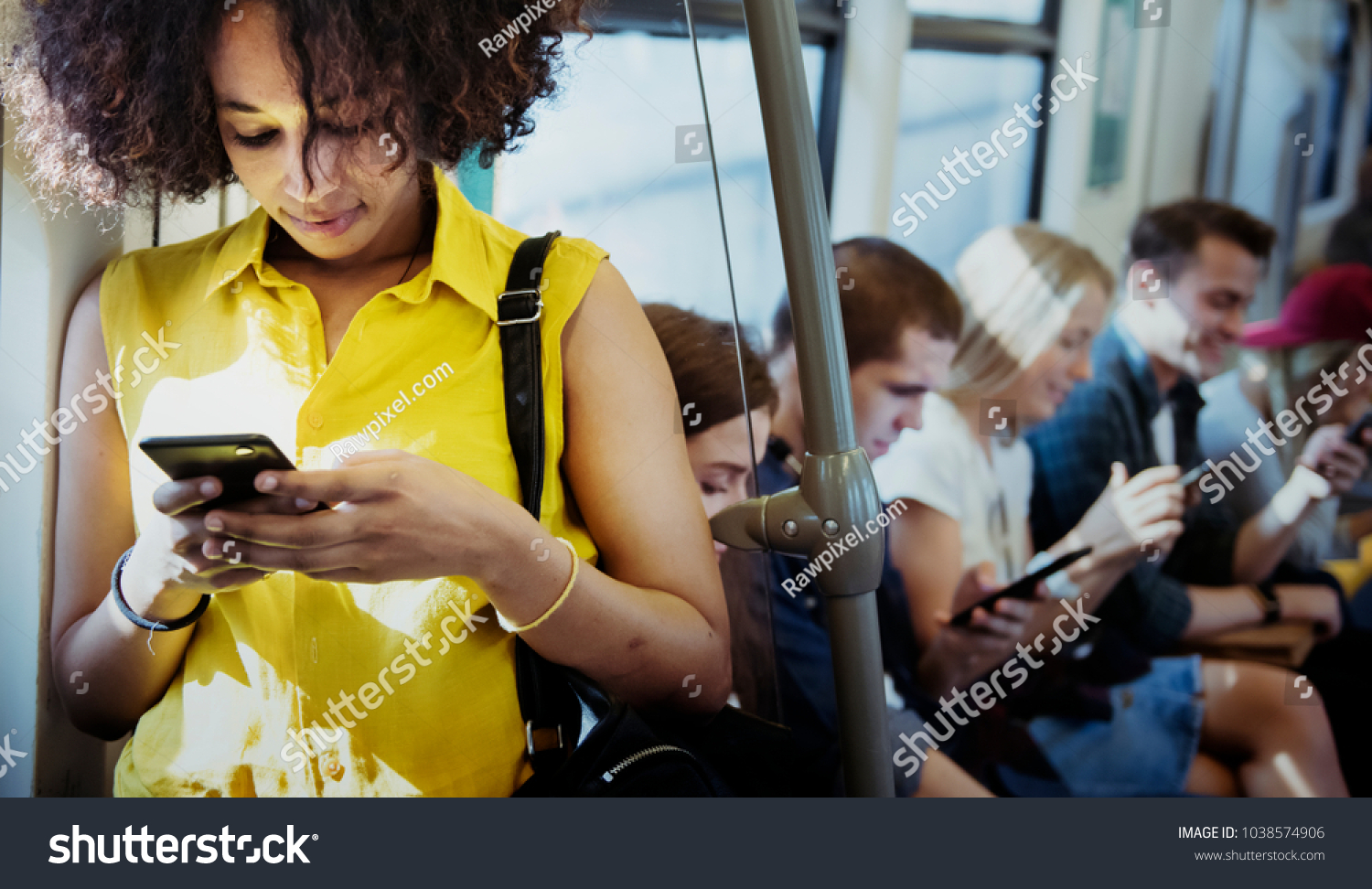 Young woman using a smartphone in a subway #1038574906