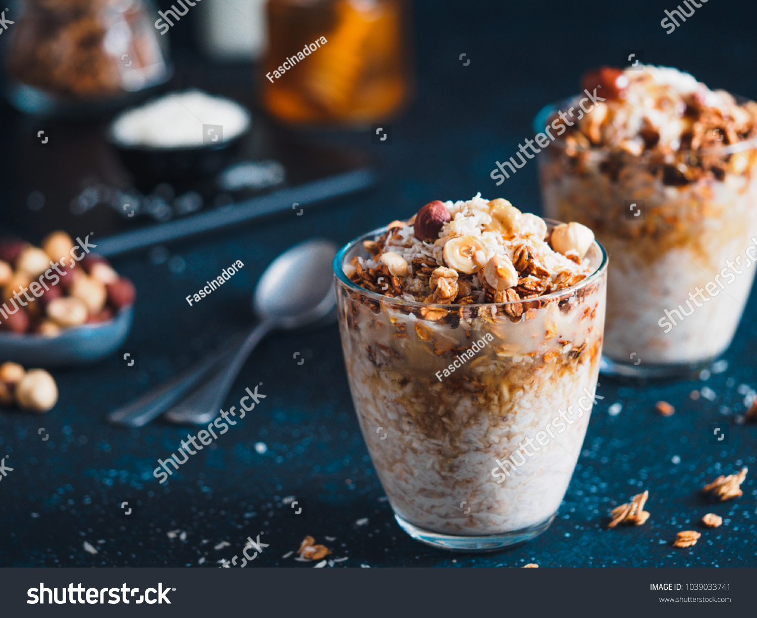 Gingerbread coconut overnight oatmeal served with granola,pecan,honey.Recipe and idea healthy vegan breakfast - plant-based milk overnight oats with chia and gingerbread spices cinnamon, nutmeg,ginger #1039033741