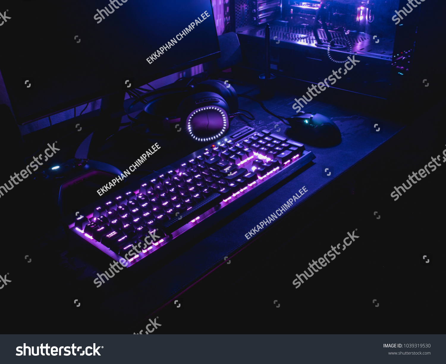 gamer workspace concept, top view a gaming gear, mouse, keyboard with RGB Color, joystick, headset, webcam, VR Headset on black table background. #1039319530