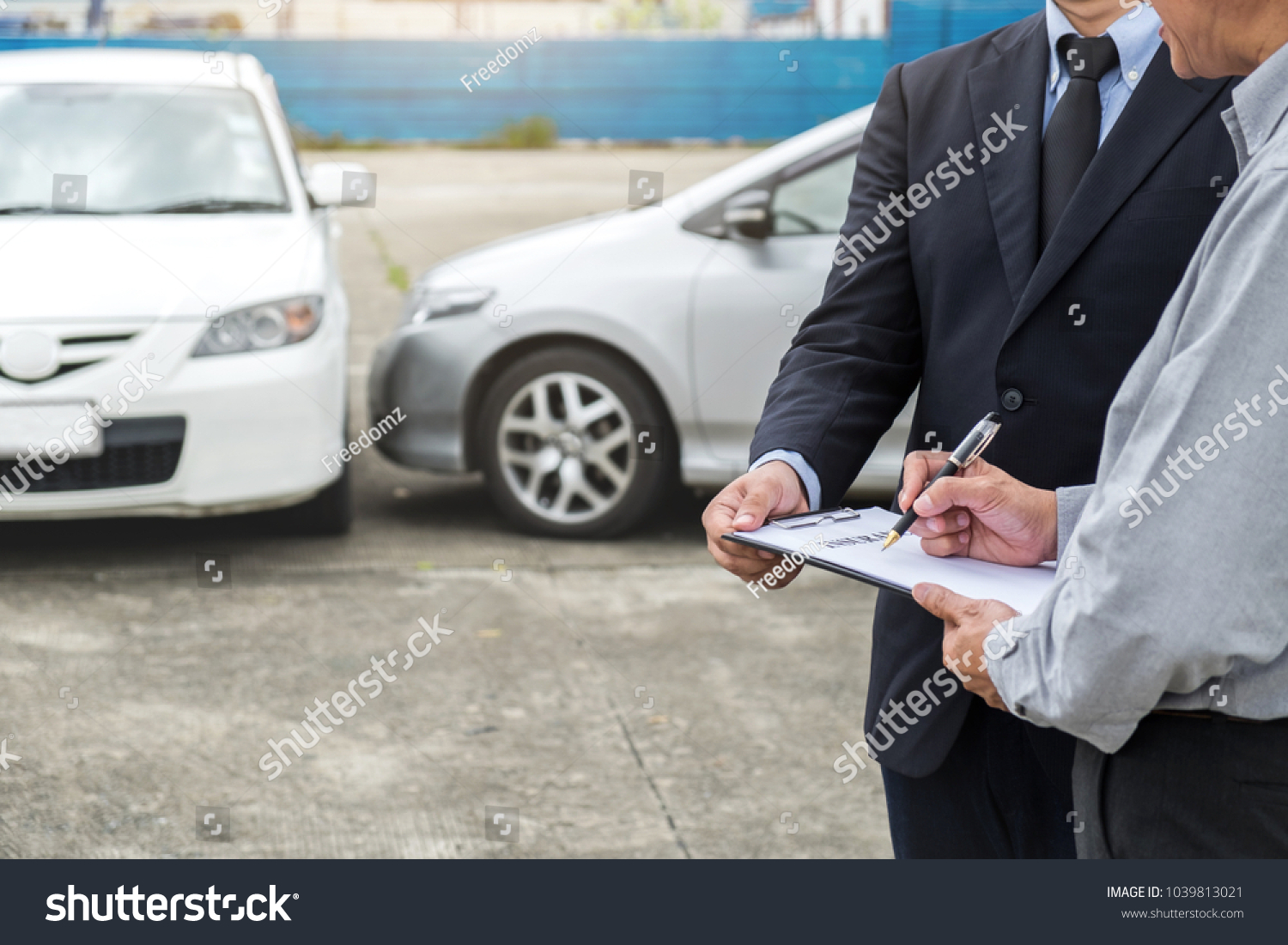 Insurance Agent examine Damaged Car and customer filing signature on Report Claim Form process after accident, Traffic Accident and insurance concept. #1039813021