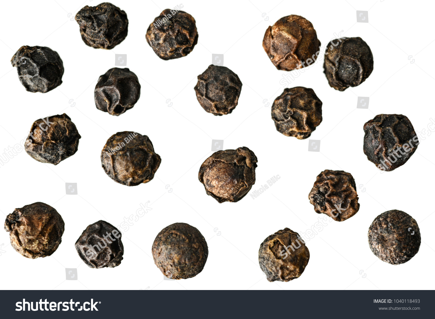Close-up image of black pepper on white background, view above, no shadows #1040118493