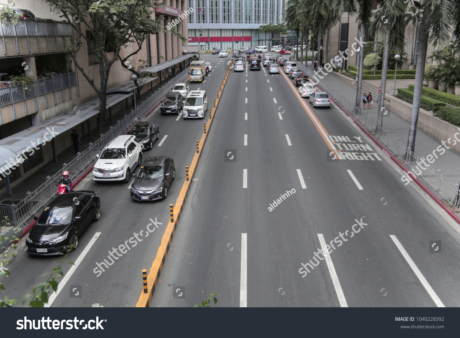 Manila, Philippines - March 6, 2018: Cars  going along the road in center of Makati #1040228392