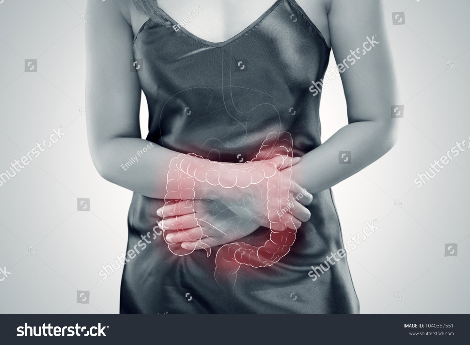Ulcerative Colitis, The photo of large intestine is on the woman's body against gray background, Female anatomy, Concept with healthcare and medicine #1040357551