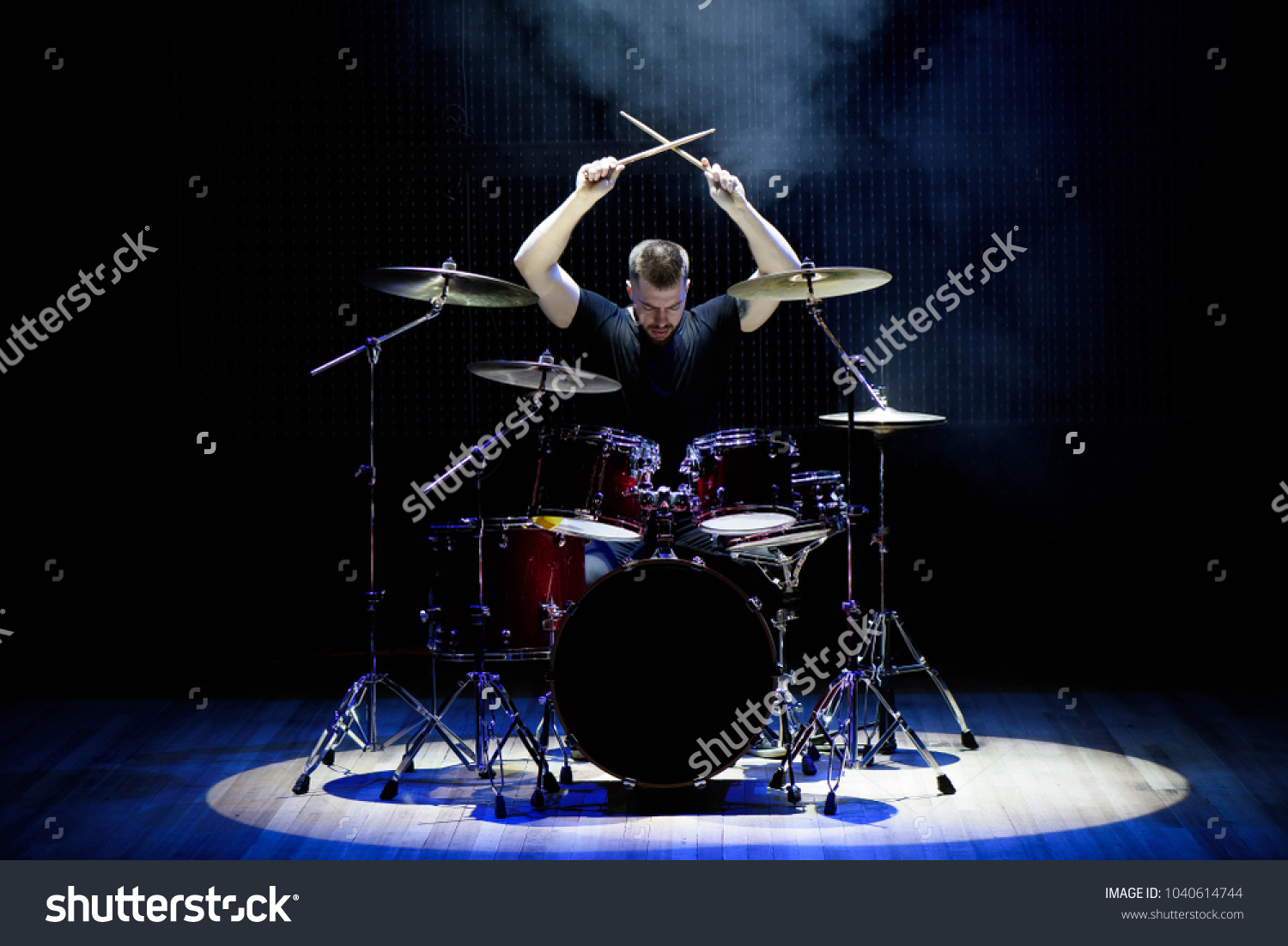 Drummer playing the drums with smoke and powder in the background #1040614744